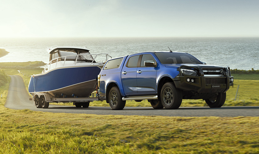 A D-MAX with lots of accessories towing a trailer