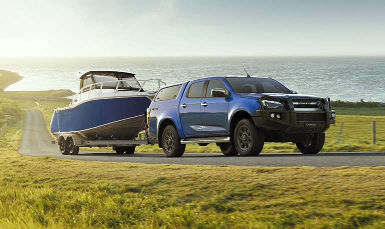 A D-MAX with lots of accessories towing a trailer